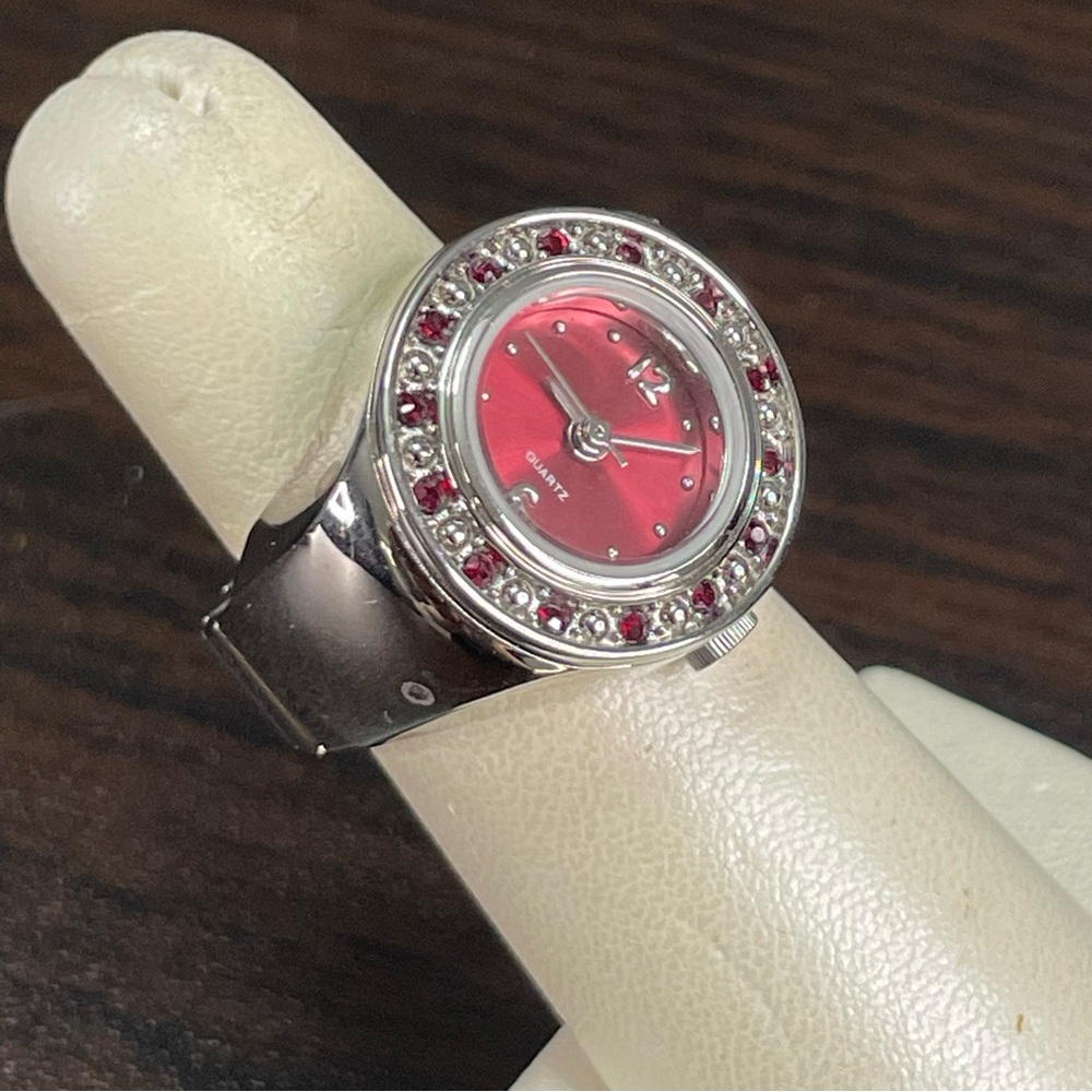 Bedazzled watch ring red gem inlay and red watch face.